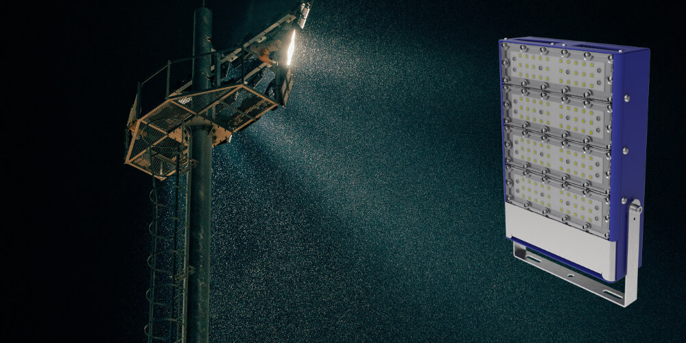 Warehouse lit by industrial LED floodlights, featuring modular LED spotlight.