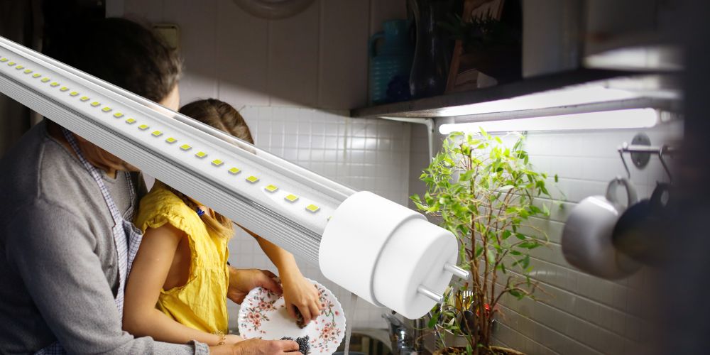 Kitchen with father and daughter washing dishes, featuring a LED tube as countertop lighting.